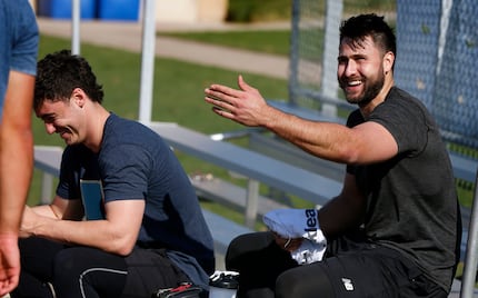 Texas Rangers first baseman Joey Gallo, right, smiles while working out with Los Angeles...