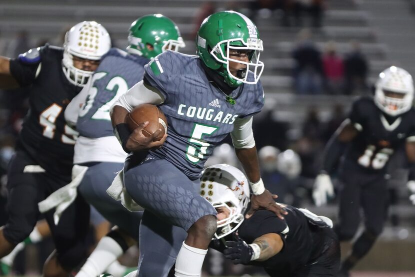 Bryan Adams running back Antoine Murphy (5) runs through a tackle from a W.T. White defender...