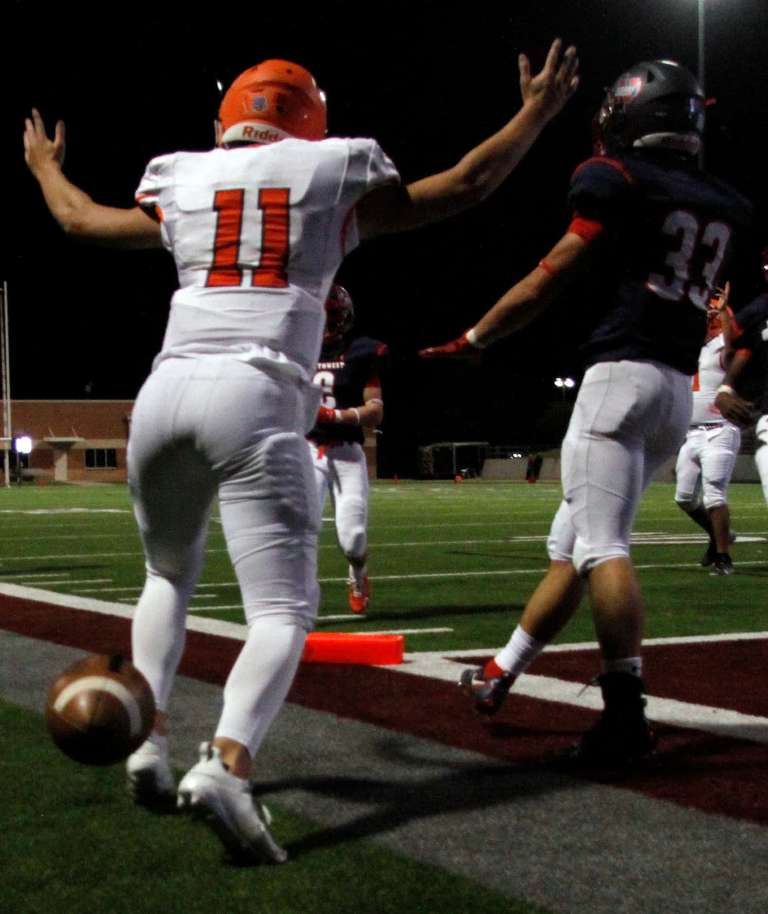 McKinney North quarterback Hayden Richardson (11) reacts after successfully diving just...