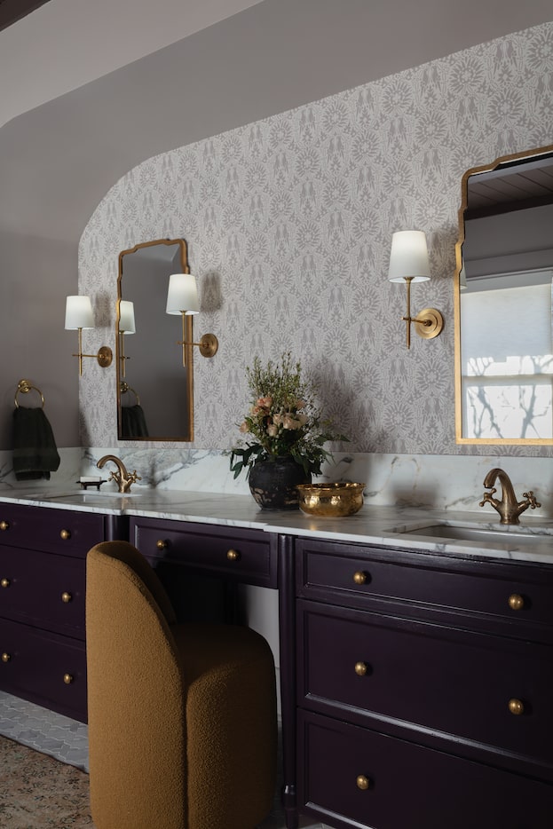 Bathroom with black vanity, white stone countertops, gray-and-white wallpaper