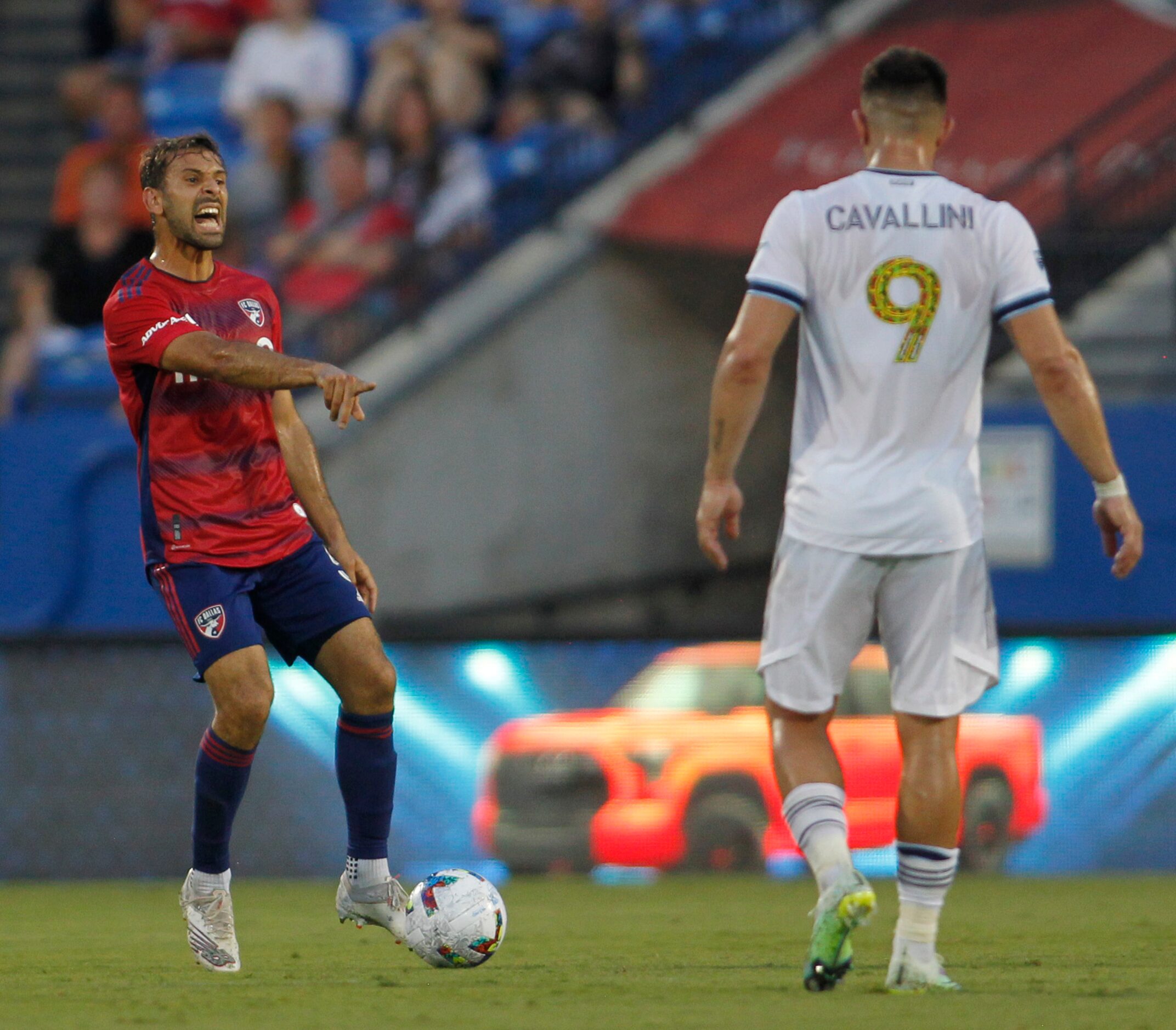 FC Dallas midfielder Fecundo Quignon (5), left, communicates with a teammate as he is...