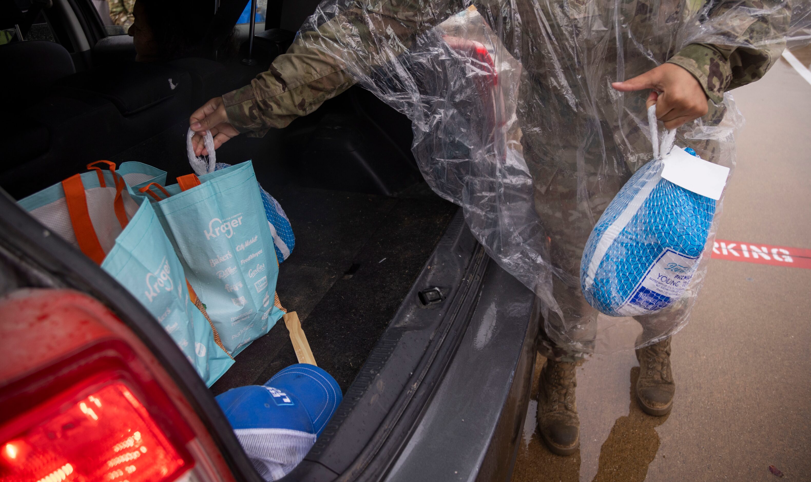 Turkeys are loaded into a car’s truck during the Hoops for Troops “Commitment to Service”...