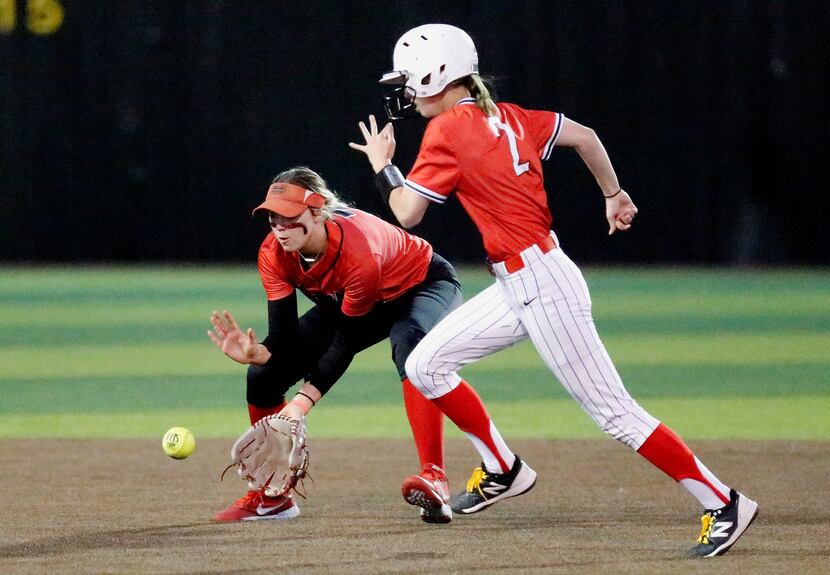Coppell High School courtesy base runner Natalie Howell (2) moves past Marcus High School...