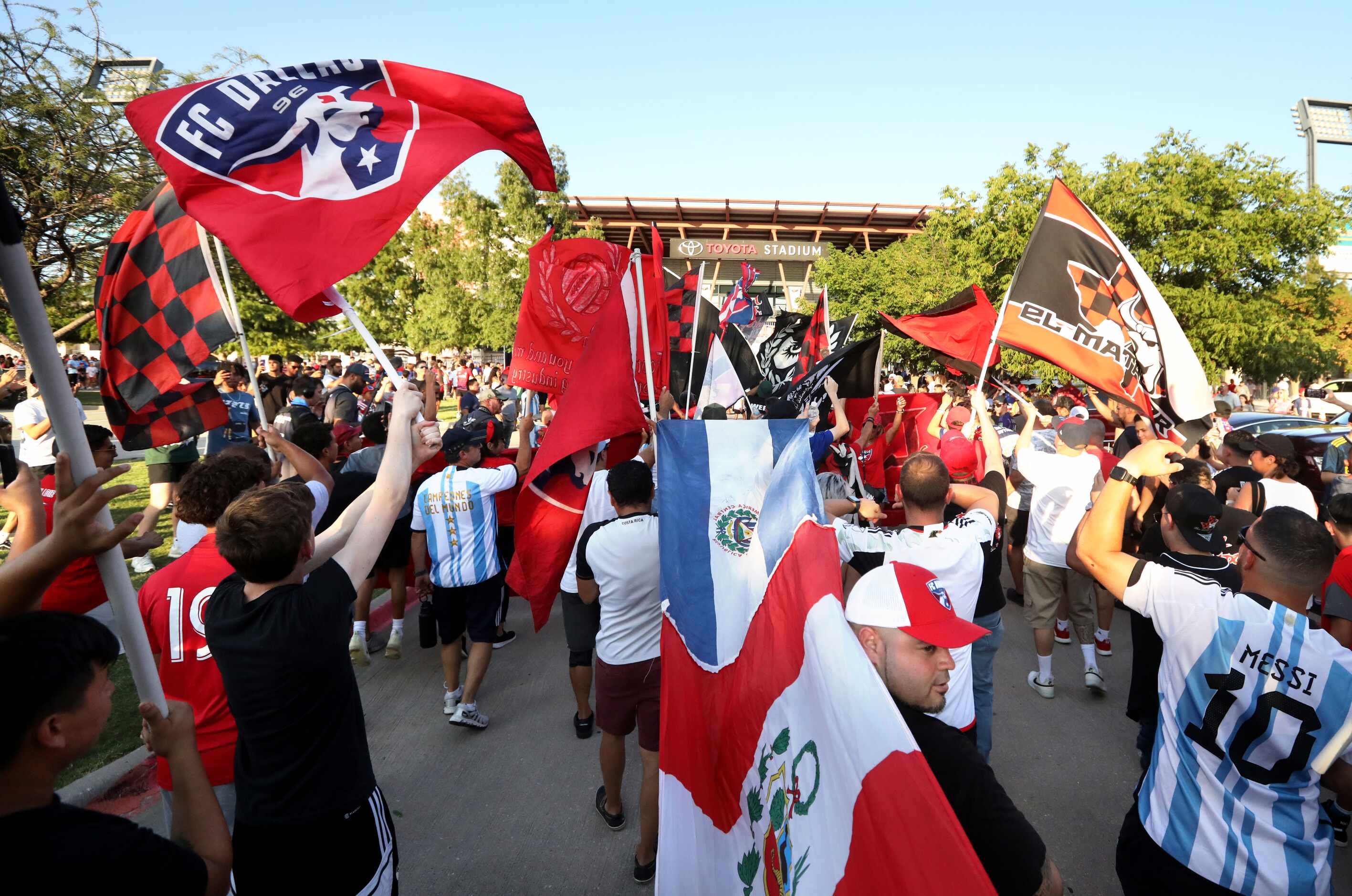 Fans join a parade as the gates to open for an FC Dallas game at Toyota Stadium in Frisco,...