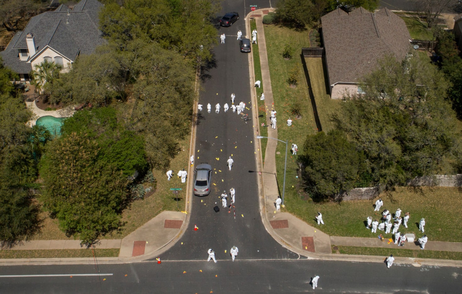 A bicycle remains in the middle of the street on Dawn Song Drive as investigators work at...