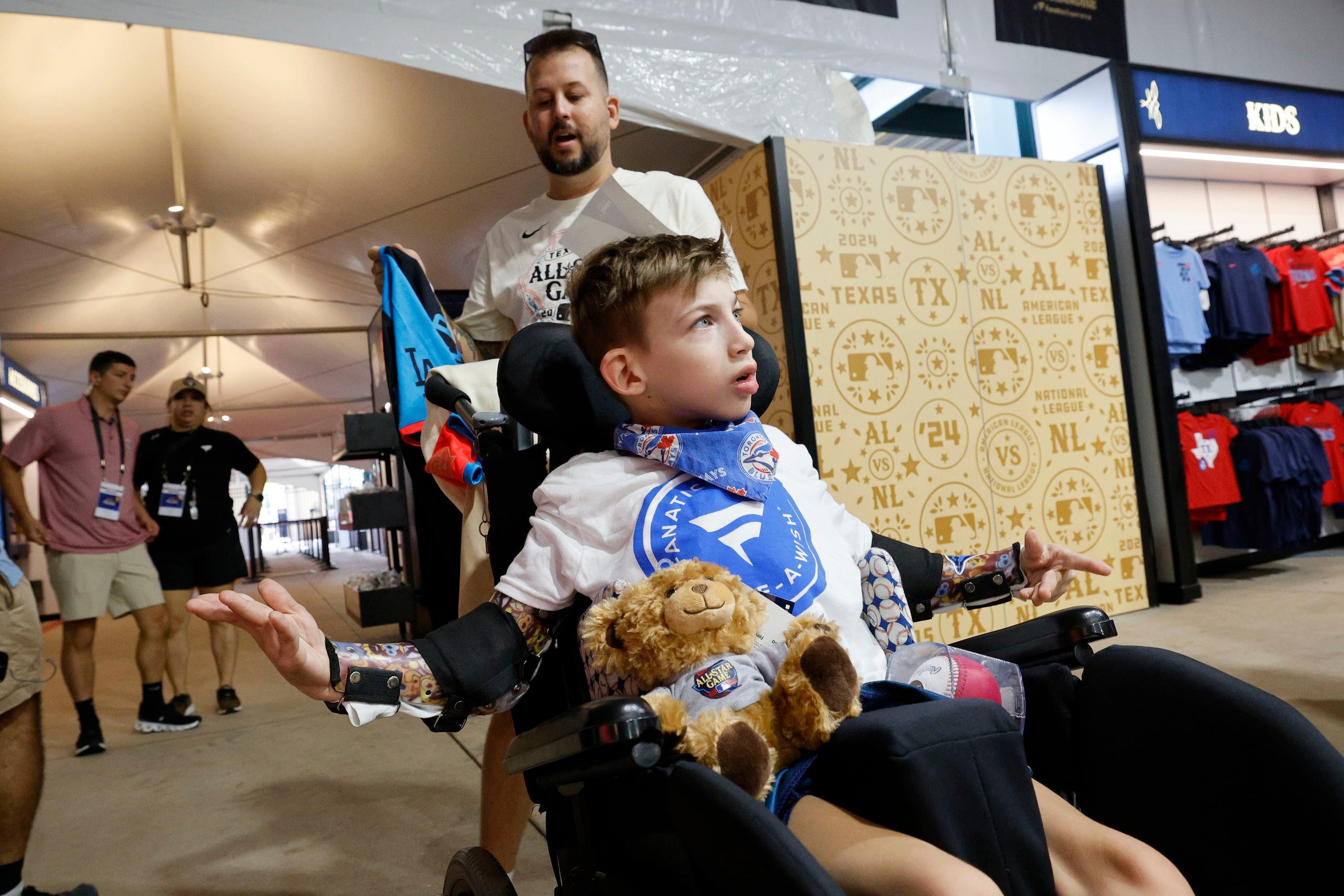 Make-a-Wish kids Holden Sisak 11, of Toronto, foreground, shops with his father Devin Sisak...