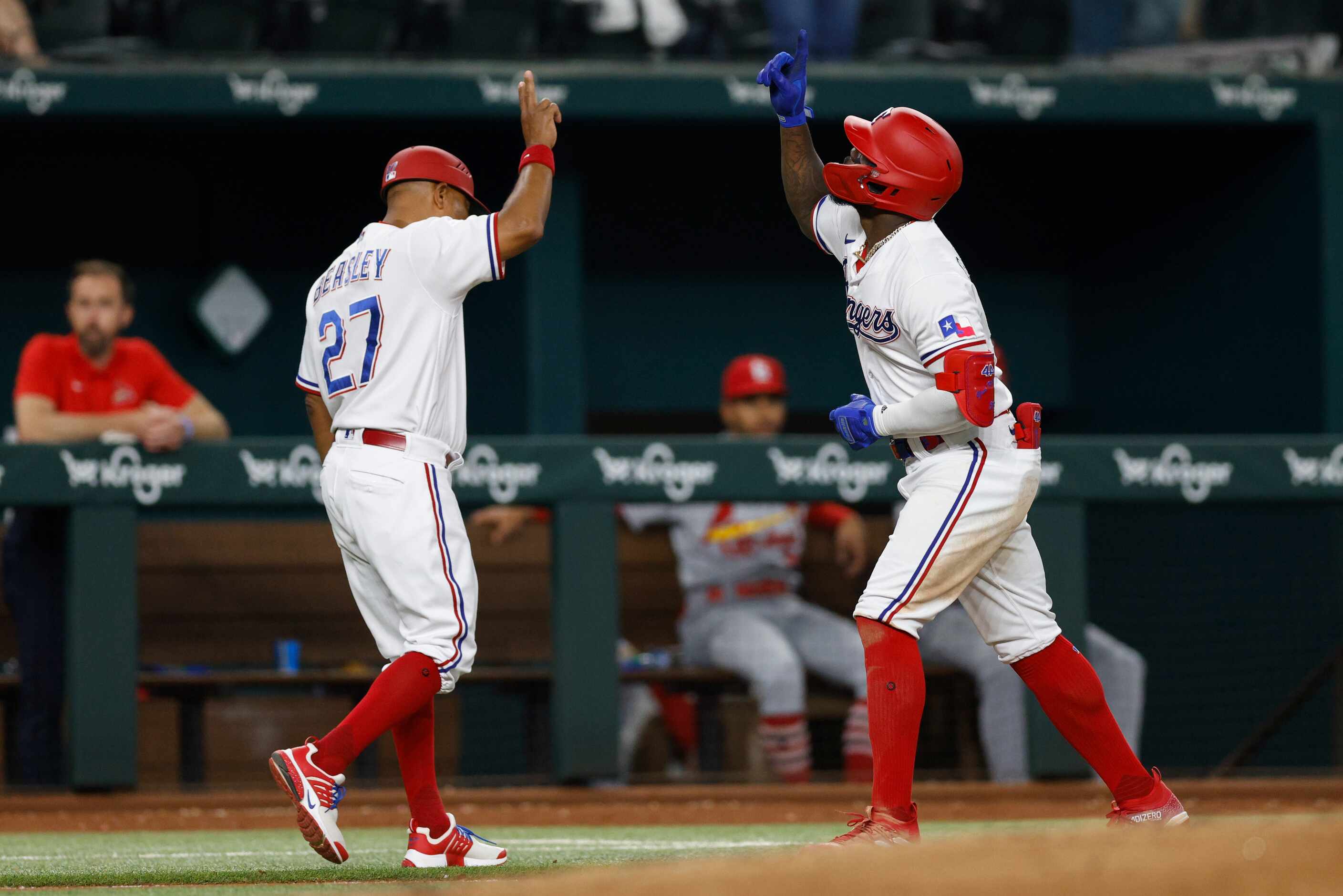 Texas Rangers right fielder Adolis Garcia (53) celebrates a home run with third base coach...