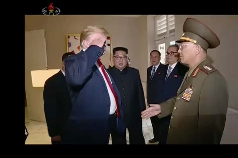 In this image made from June 12, 2018, video released by KRT, President Donald Trump salutes...