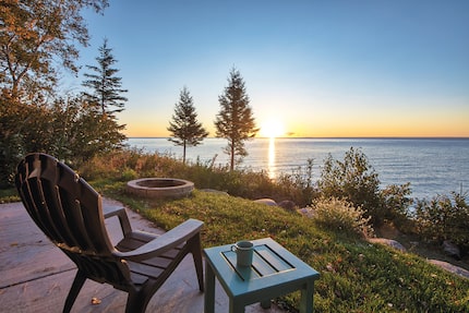 chair by a lake at sunset