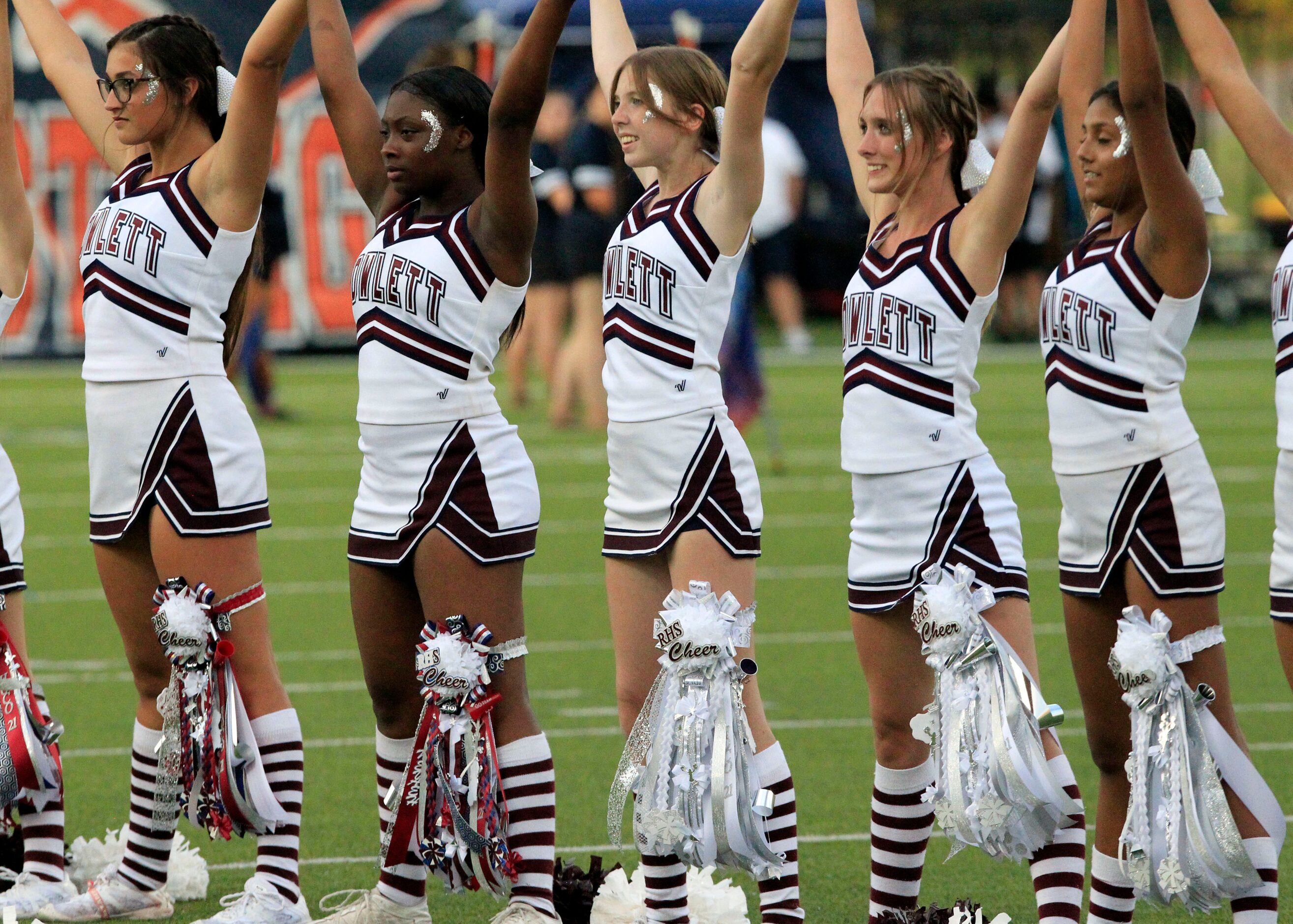 The Rowlett cheerleaders sport leg mums during homecoming festivities before the start of a...