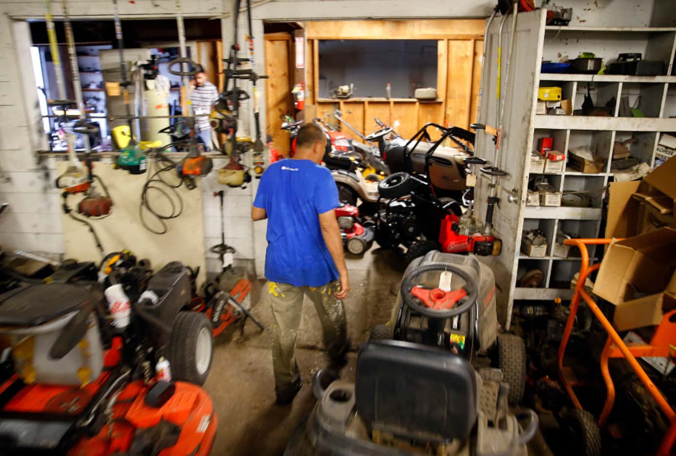 Small engine repairman Ruben Rosas walks among the many projects he has yet to finish at...