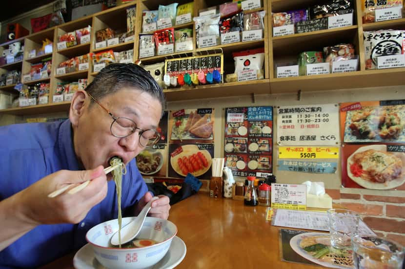 Masaya Sokusekisai Oyama, 55, slurps noodles at a Tokyo shop and restaurant specializing...