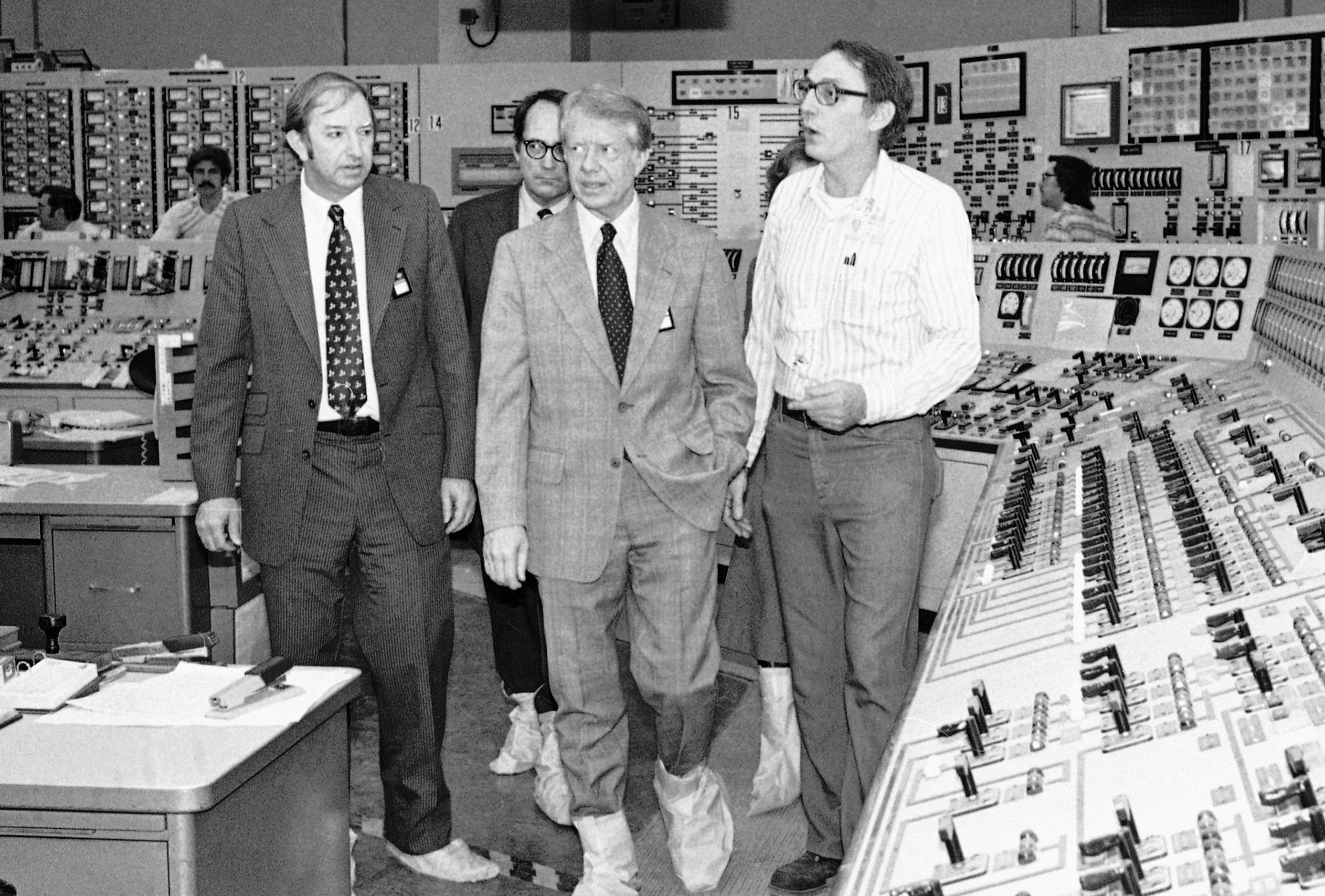 Harold Denton (left) with President Jimmy Carter (center) on a tour of the control room at...