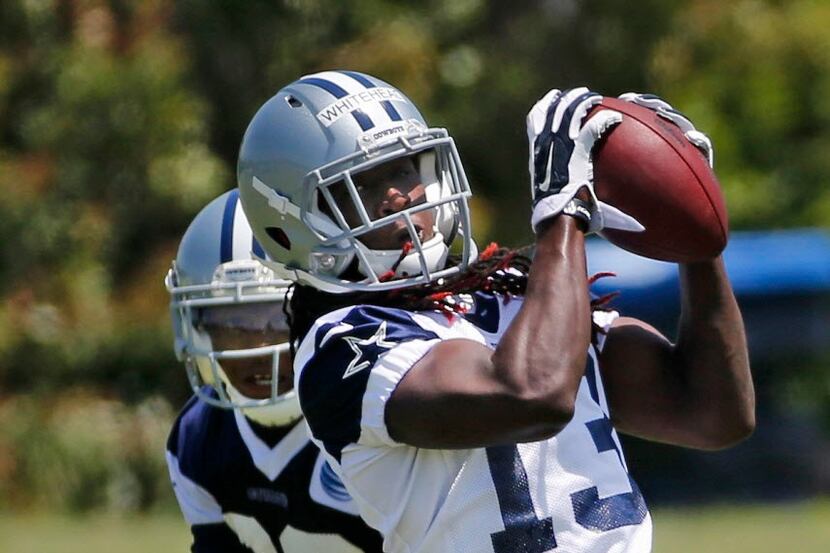 Dallas Cowboys receiver Lucky Whitehead (13) catches a pass during the teams' OTA workout at...