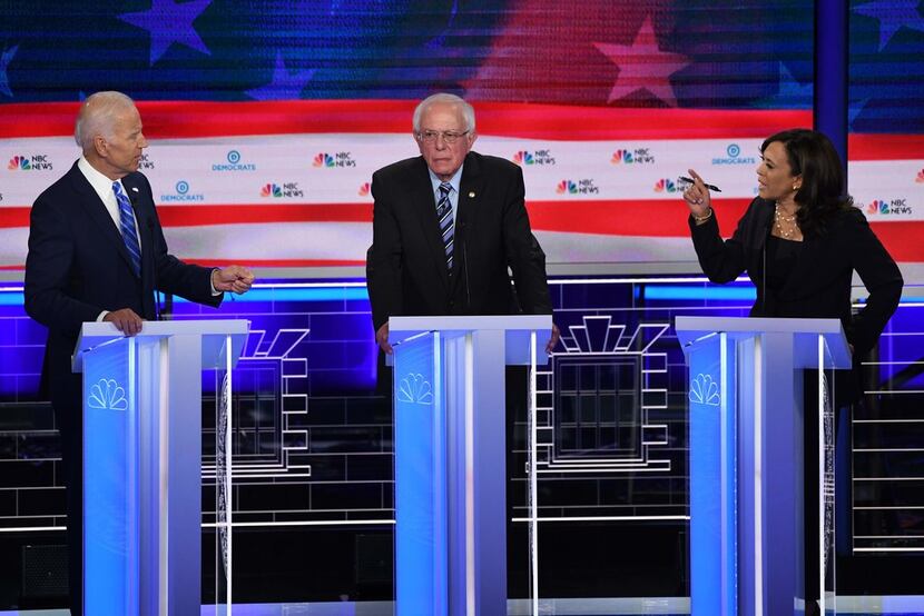 Democratic presidential hopefuls Joe Biden and Kamala Harris speak across candidate Bernie...