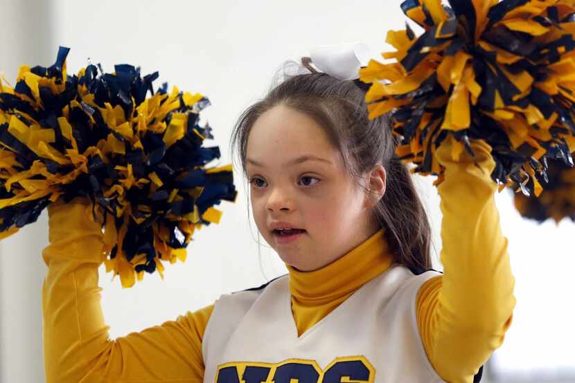 
Samantha Gonzales, 13 shakes her pompoms March 17 during cheer squad practice at Notre Dame...