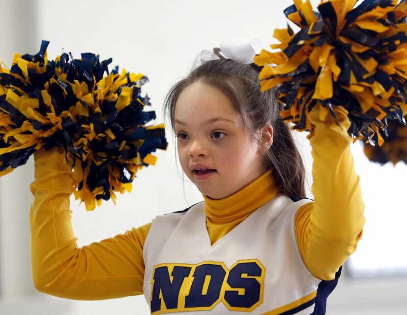 
Samantha Gonzales, 13 shakes her pompoms March 17 during cheer squad practice at Notre Dame...
