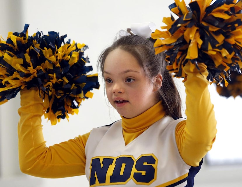 
Samantha Gonzales, 13 shakes her pompoms March 17 during cheer squad practice at Notre Dame...