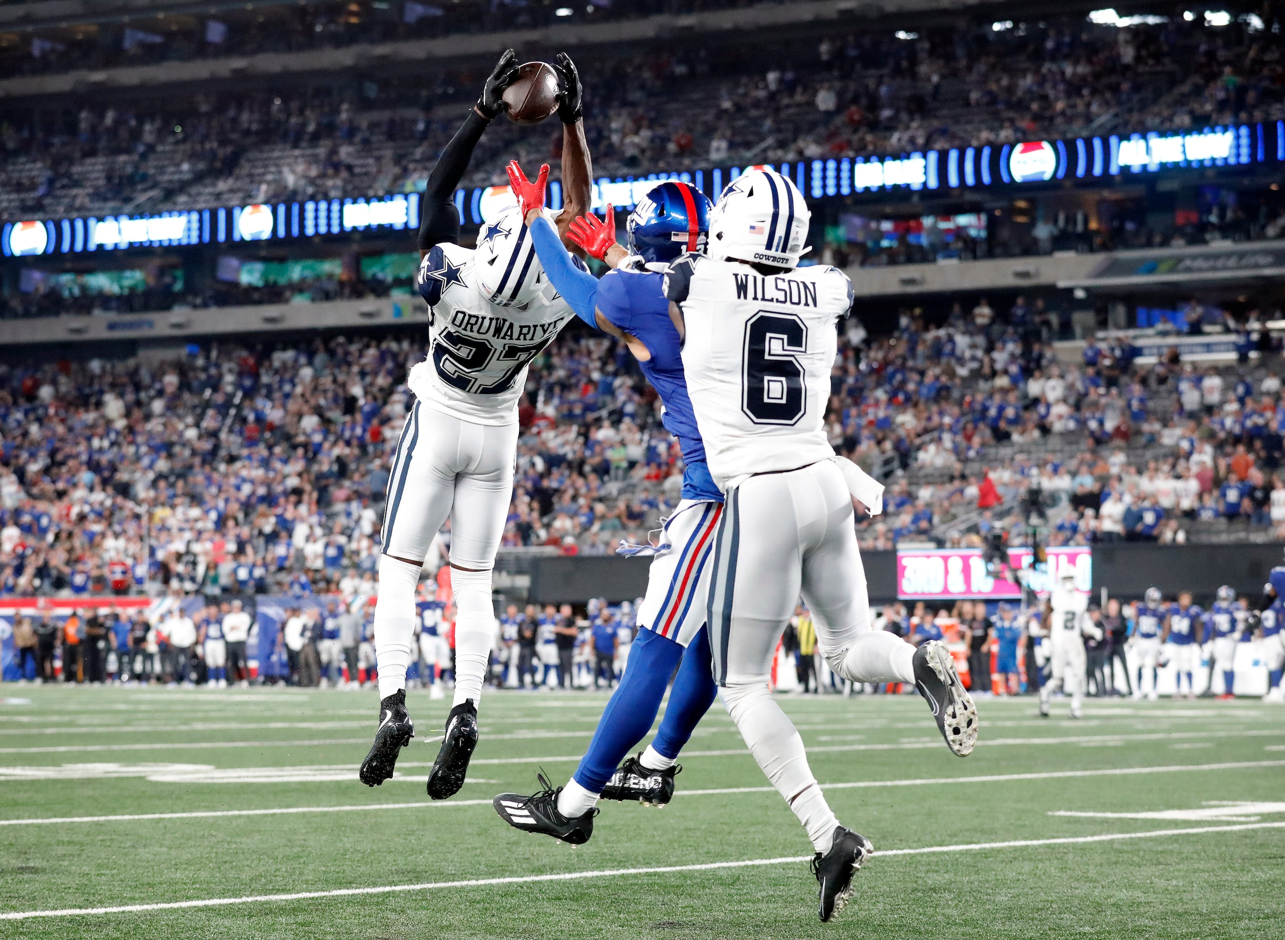 Dallas Cowboys cornerback Amani Oruwariye goes high to intercept a late fourth quarter pass...