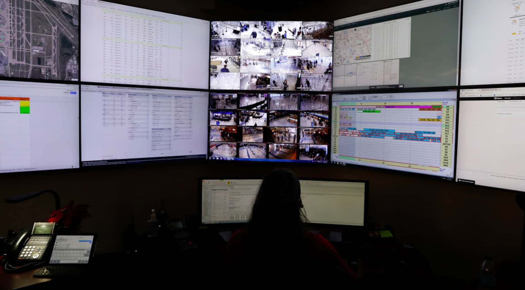 DFW International Airport customer service center personnel watched monitors in Terminal D...