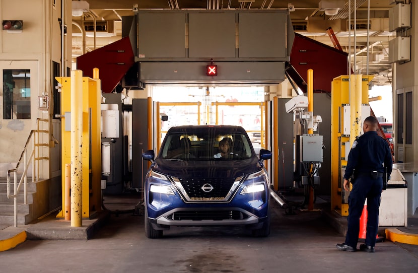 A U.S. Customs and Border Protection officer watches a traveler drive through a Z Portal ...