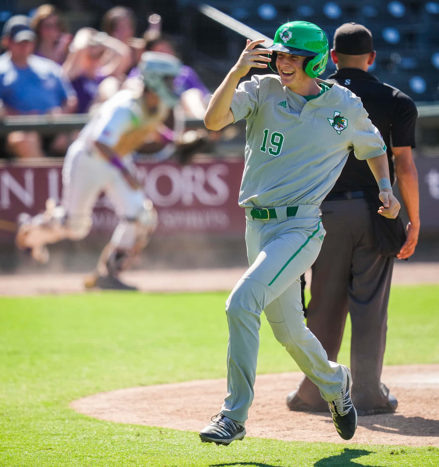 Southlake Carroll outfielder Tanner Sumer celebrates after scoring from third after the ball...