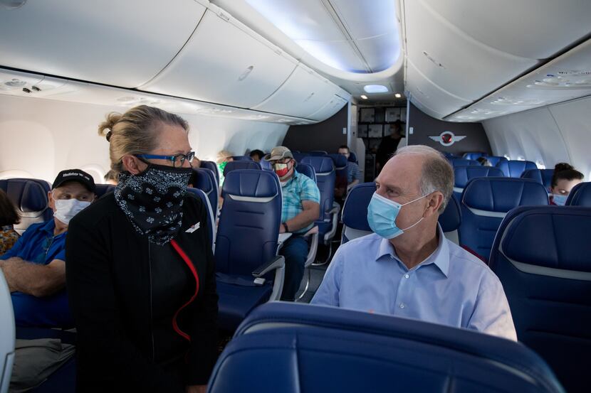 Gary Kelly chats with a flight attendant during a trip to Denver International Airport in...