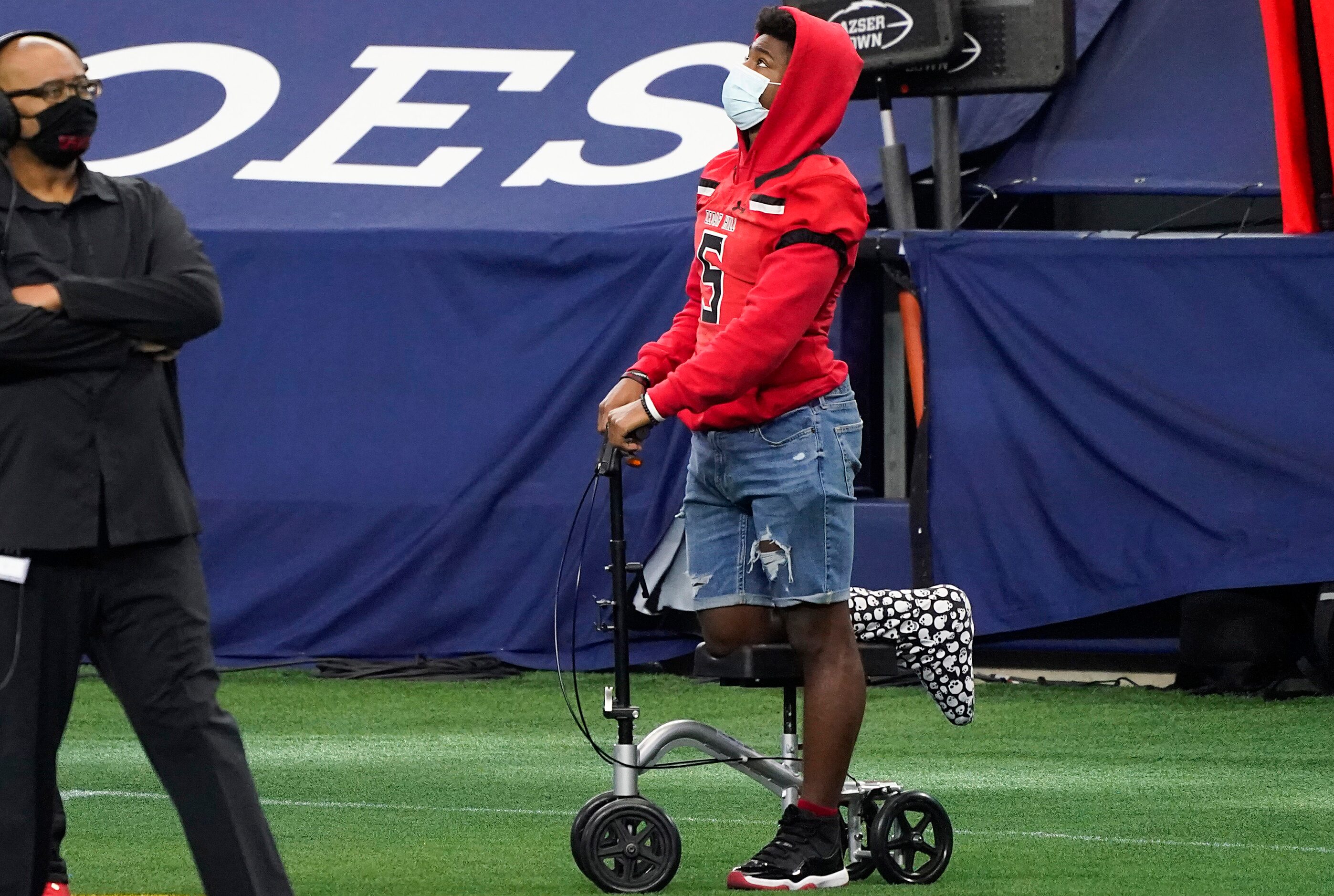 Injured Cedar Hill running back Kevin Young, Jr (5) watches from the sidelines during the...