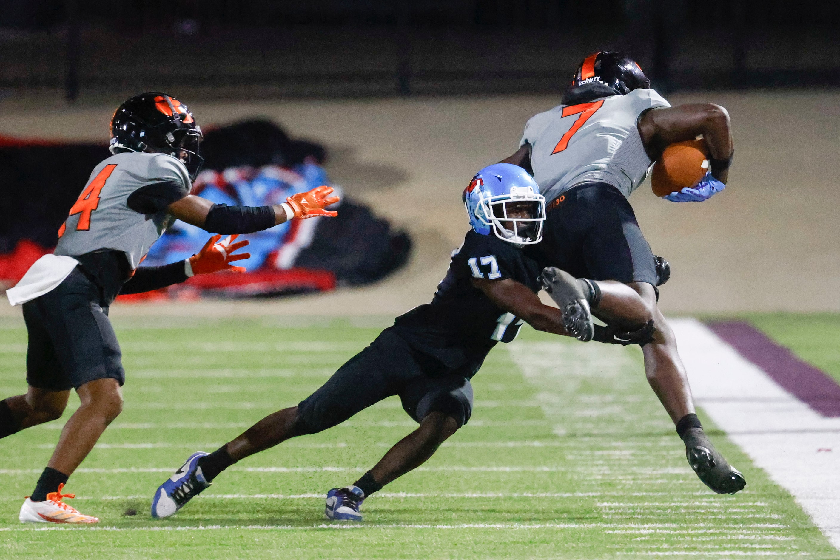 Skyline High’s A’Niaus Anderson (center) tackles Lancaster High’s Dakeriean Johnson during...