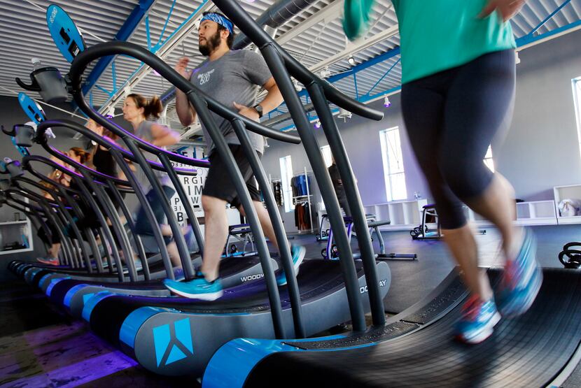 A group exercise class uses treadmills at BEYOND 500 fitness studios, on Tuesday, Nov. 25,...
