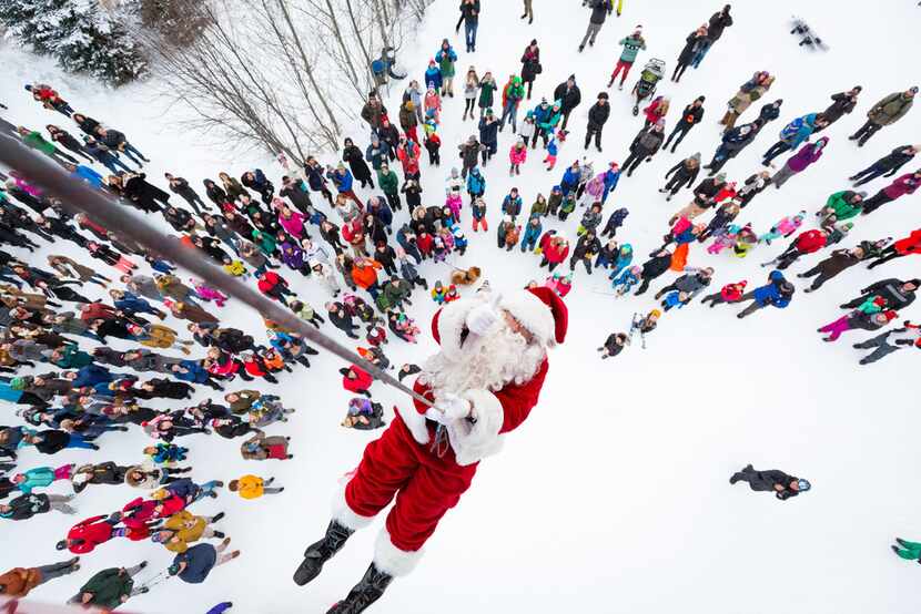 Santa drops in at the Jackson Hole Mountain Resort on Christmas Eve, rappelling onto the...