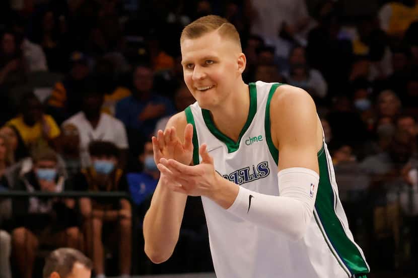 Dallas Mavericks center Kristaps Porzingis (6) cheers his team on after a made basket in a...