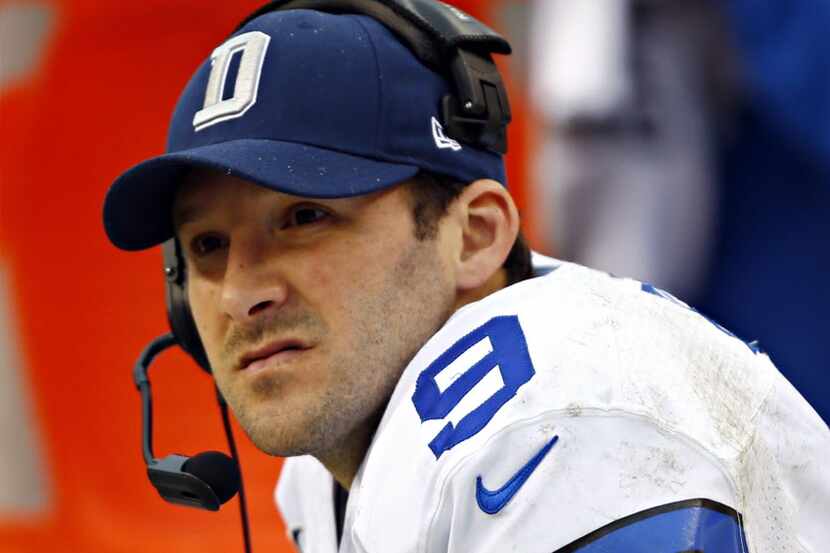Dallas Cowboys quarterback Tony Romo looks on from the bench as Dallas trails the Washington...