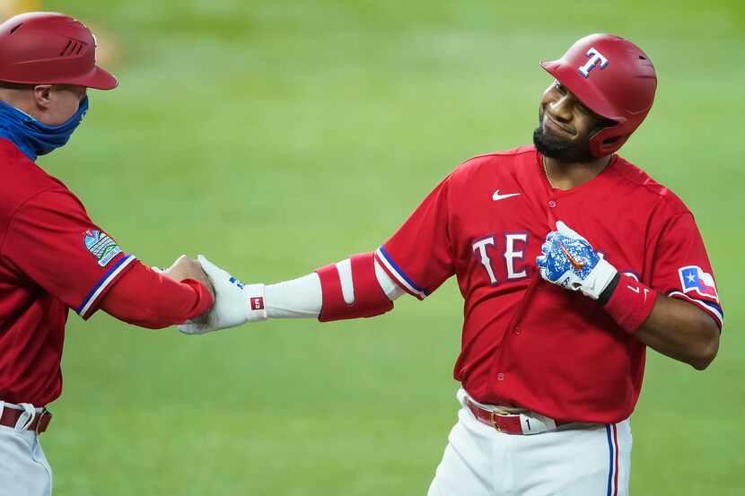 Texas Rangers shortstop Elvis Andrus celebrates with first base coach Corey Ragsdale after...