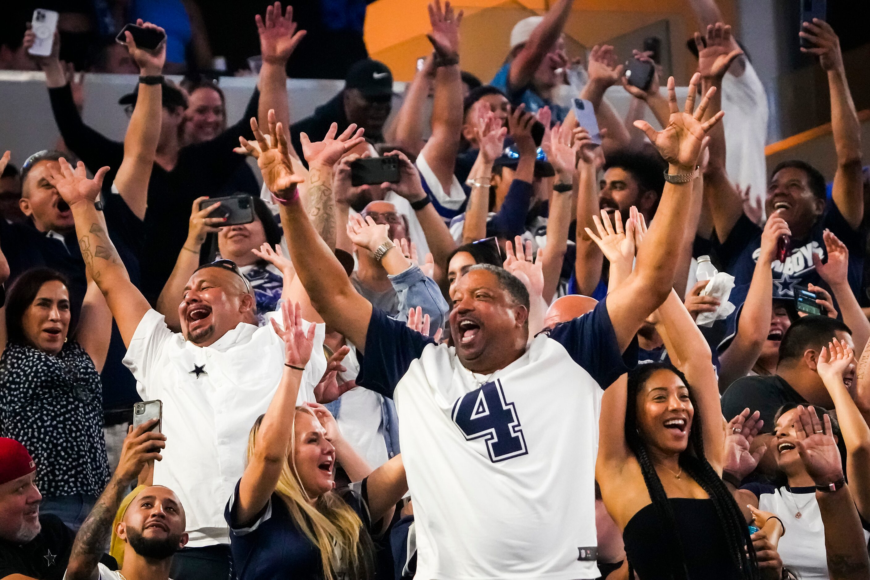 Dallas Cowboys fans do the wave during the fourth quarter of an NFL preseason football game...