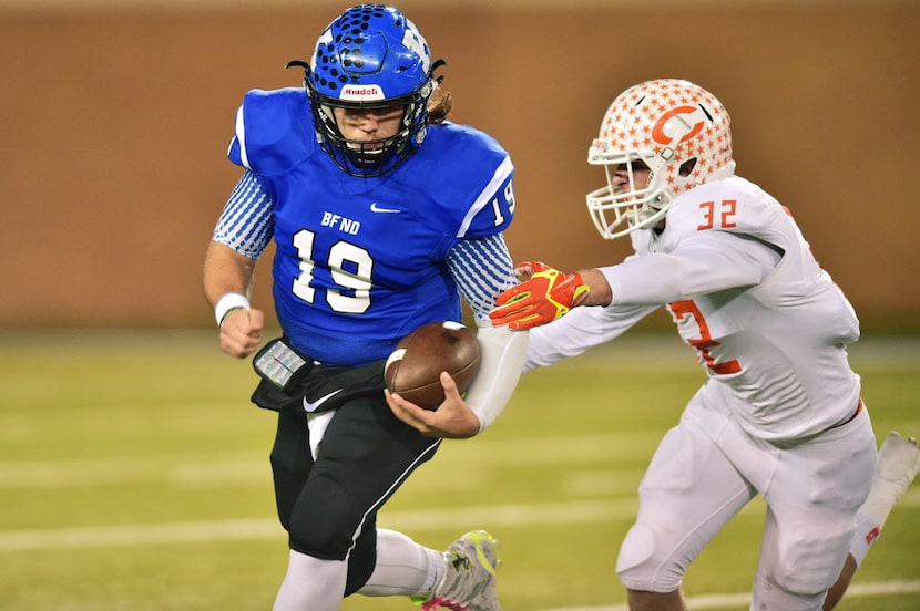 Krum senior quarterback Colten Graham (19) tries to run wide around Celina junior linebacker...