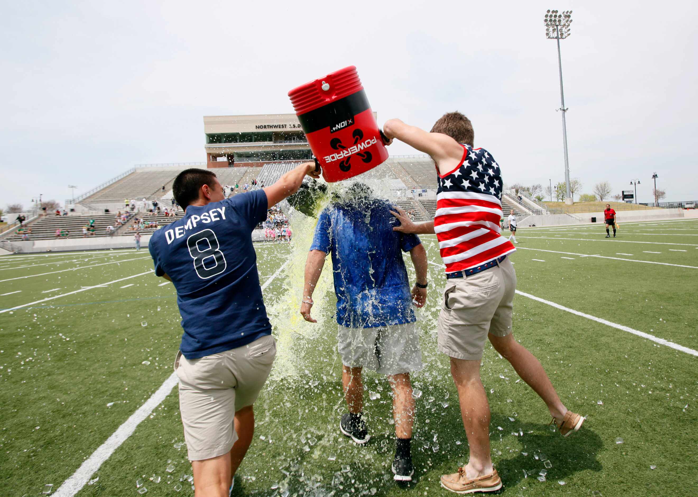 Hebron seniors Joel Carlos, left, and Tyler Zych, dump a water cooler of Gatorade and ice on...