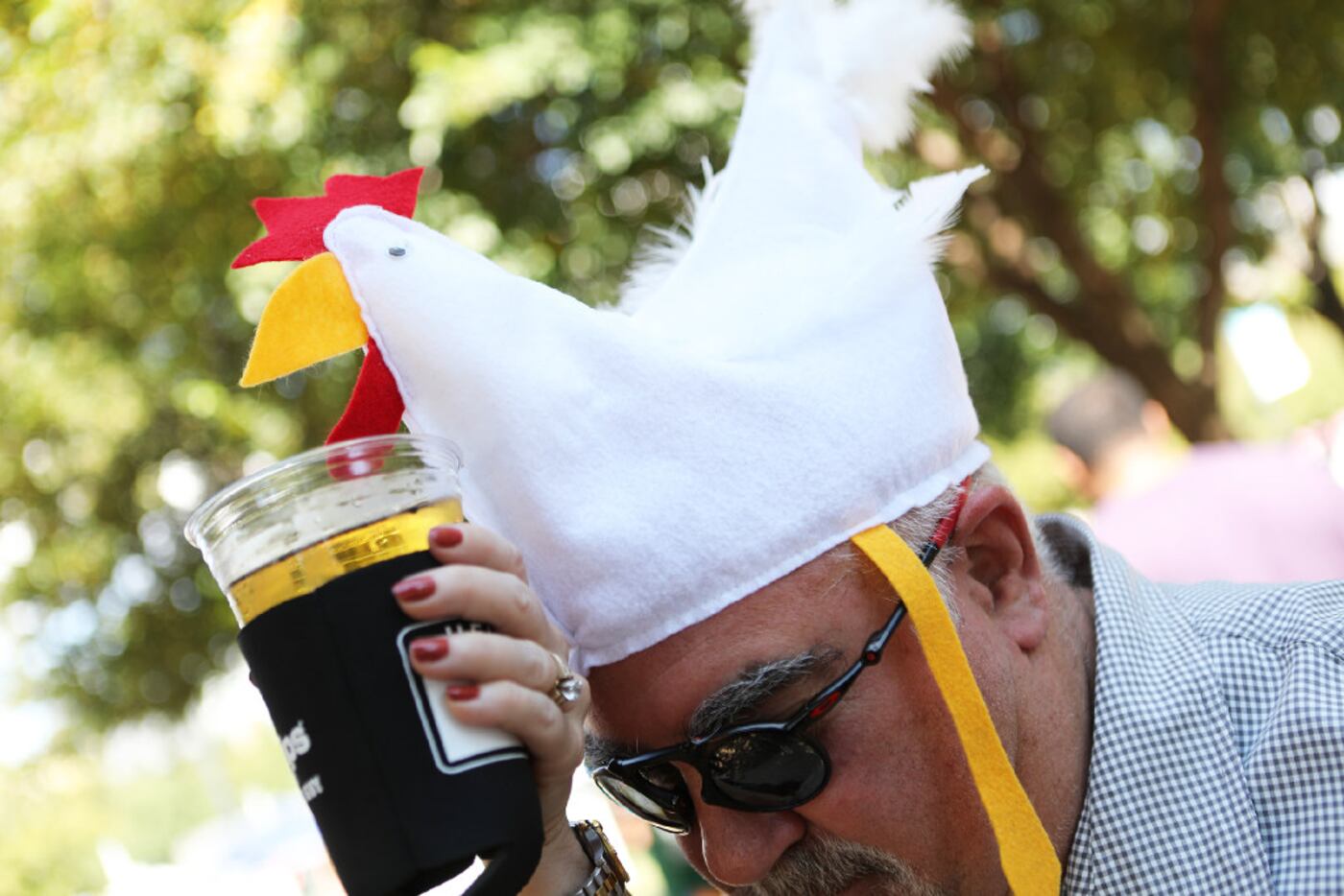 Dirk Johnston gives his parched chicken hat a drink during Addison Oktoberfest on Sept. 17,...