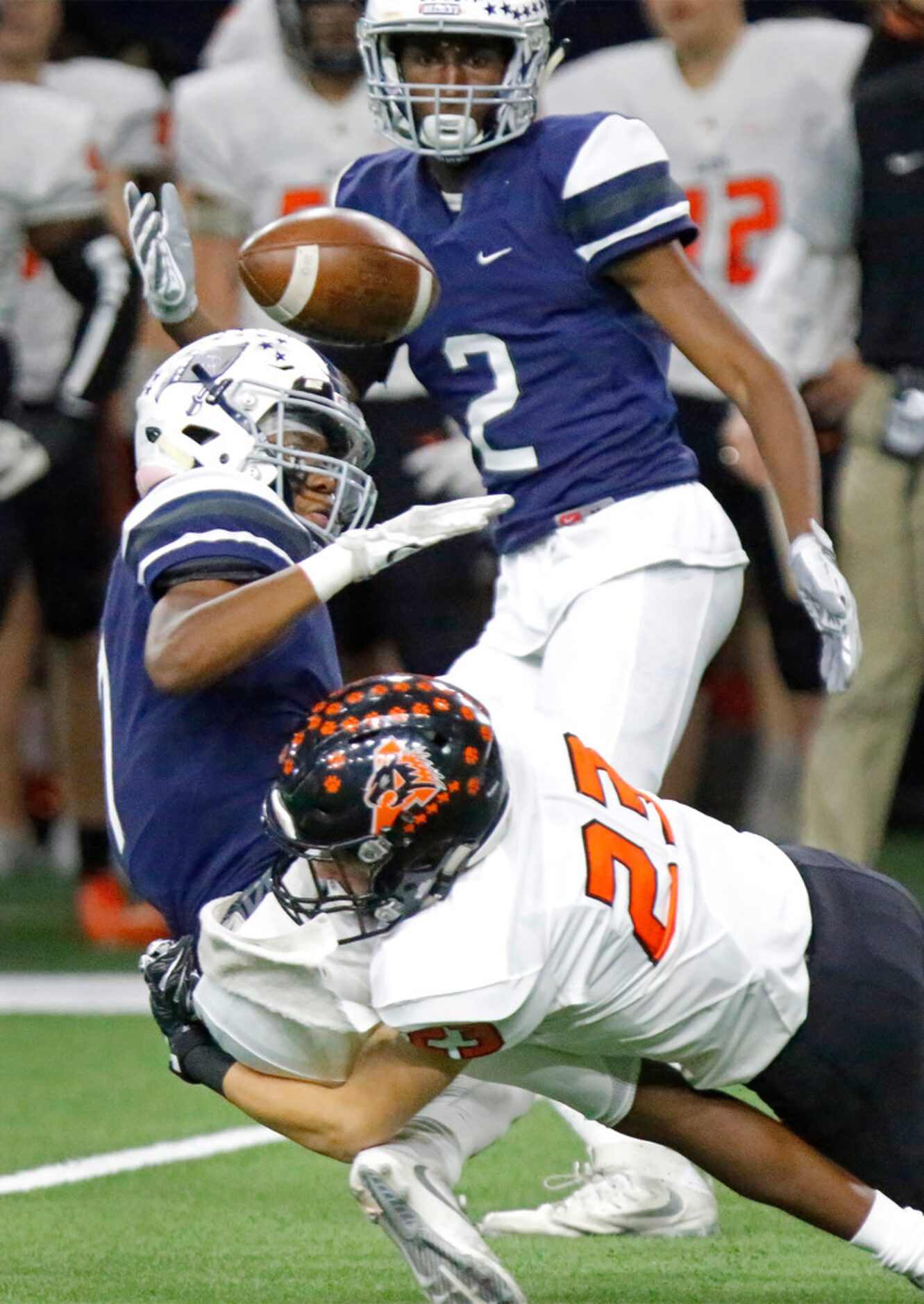 Richland High School kick returner Shamar Johnson (7) looses the football as he is hit by...