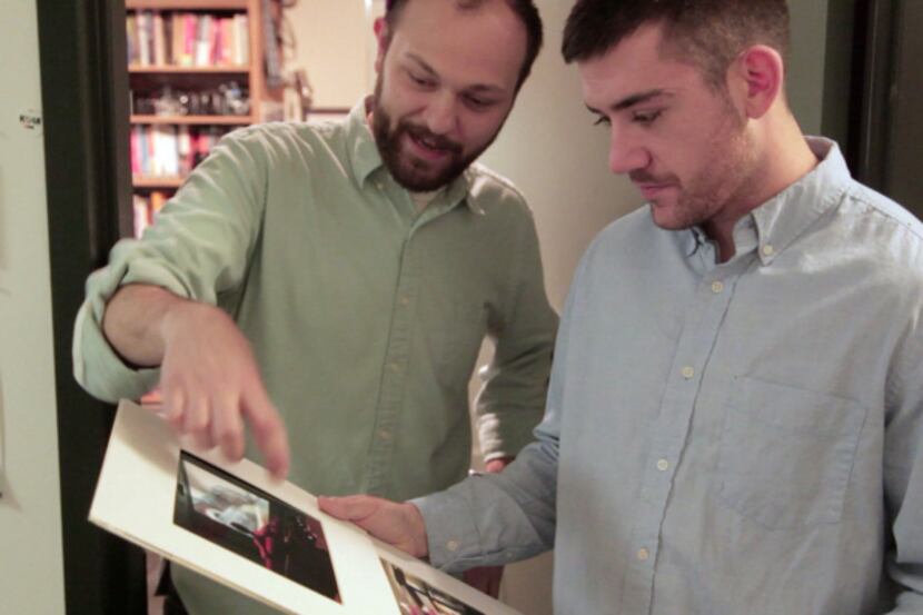 Instructor Daniel Rodrigue (left) returned a finished photo project to Derek Madrigal as he...