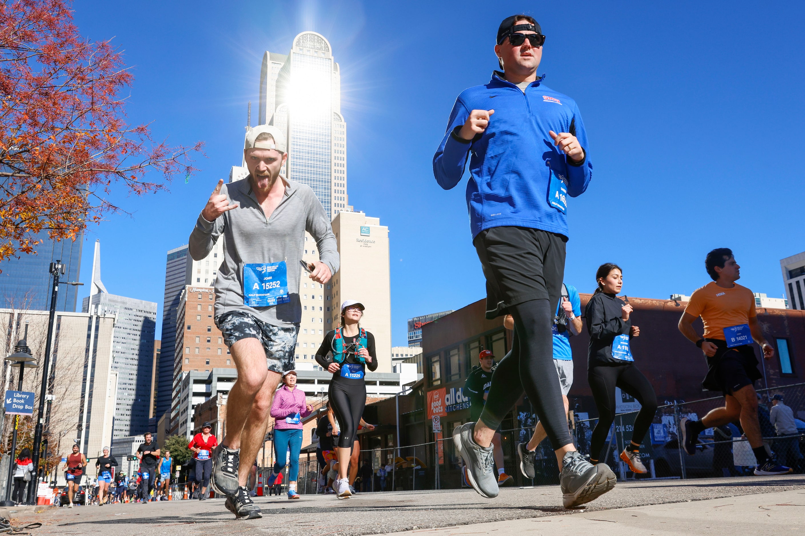 A runner reacts towards the camera as he including other run along South Ervay St. during...