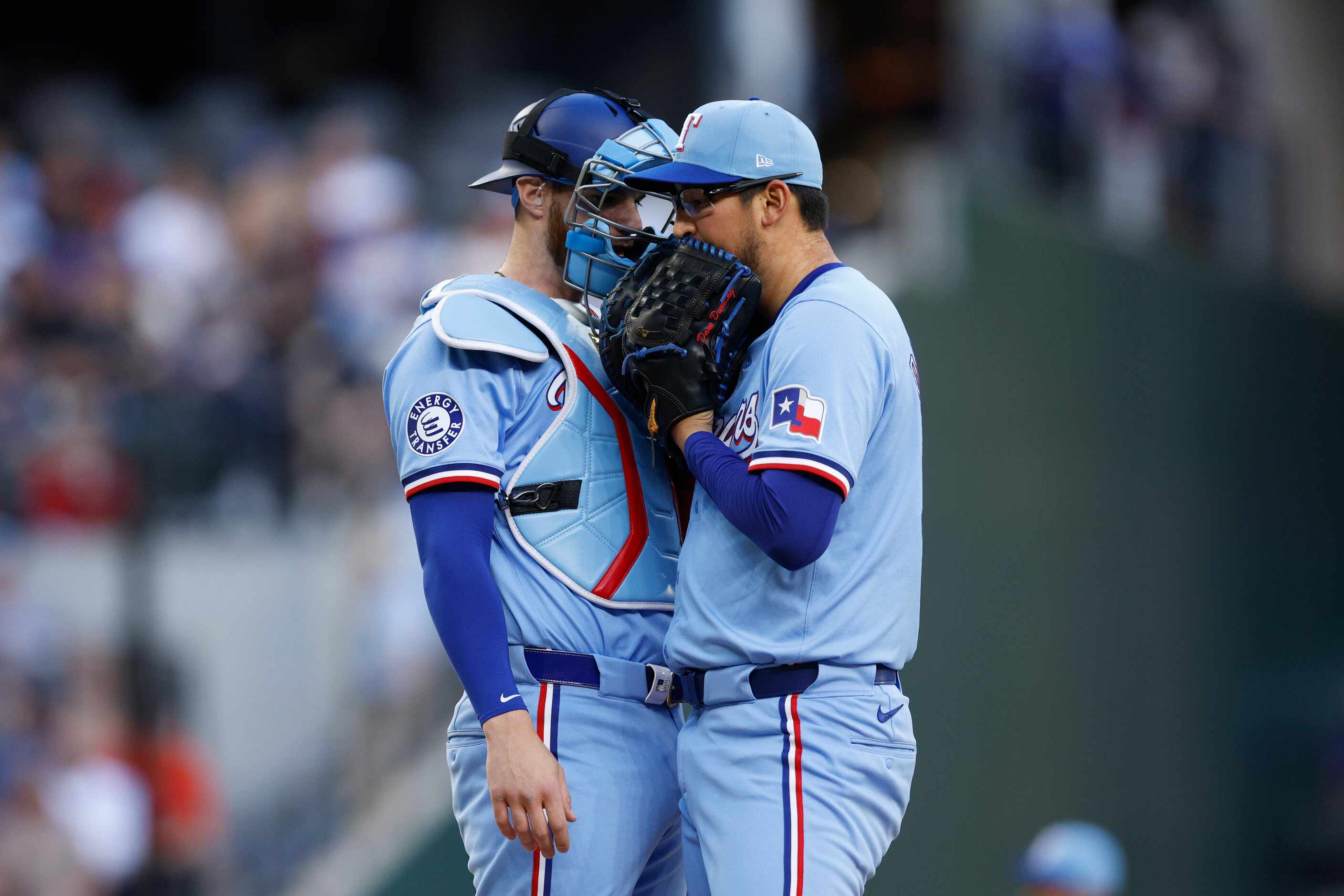 Texas Rangers catcher Jonah Heim talks with starting pitcher Dane Dunning (33) during the...