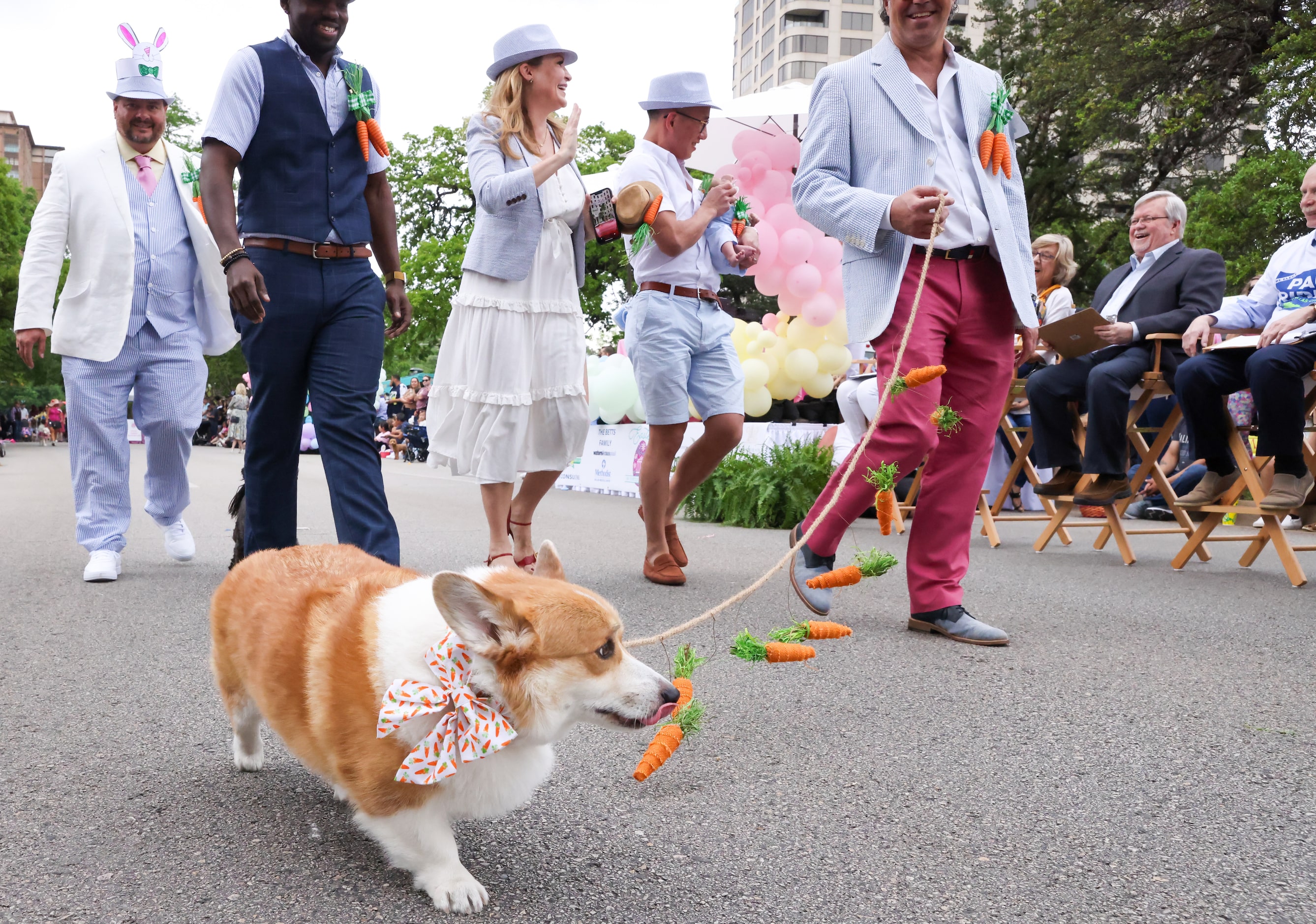 A group entry for the Pooch Parade turn to the judges as they move down Turtle Creek...