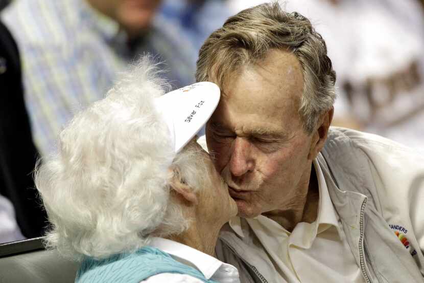 FILE - In this May 5, 2010 file photo, former U.S. President George H.W. Bush, right, kisses...