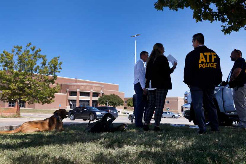 ATF officials gather in front of Mansfield Timberview High School in Arlington following a...