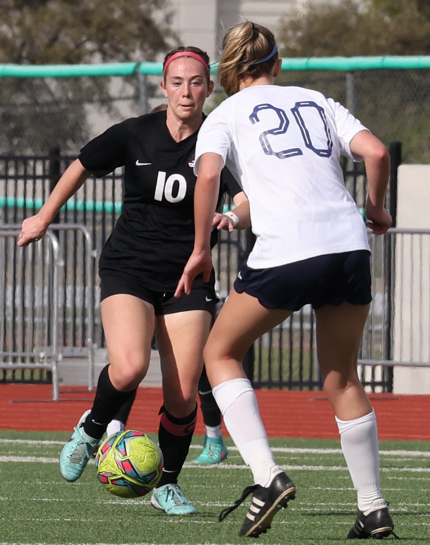 Flower Mound Marcus midfielder Allie Williams (10) controls the ball as Richardson JJ Pearce...