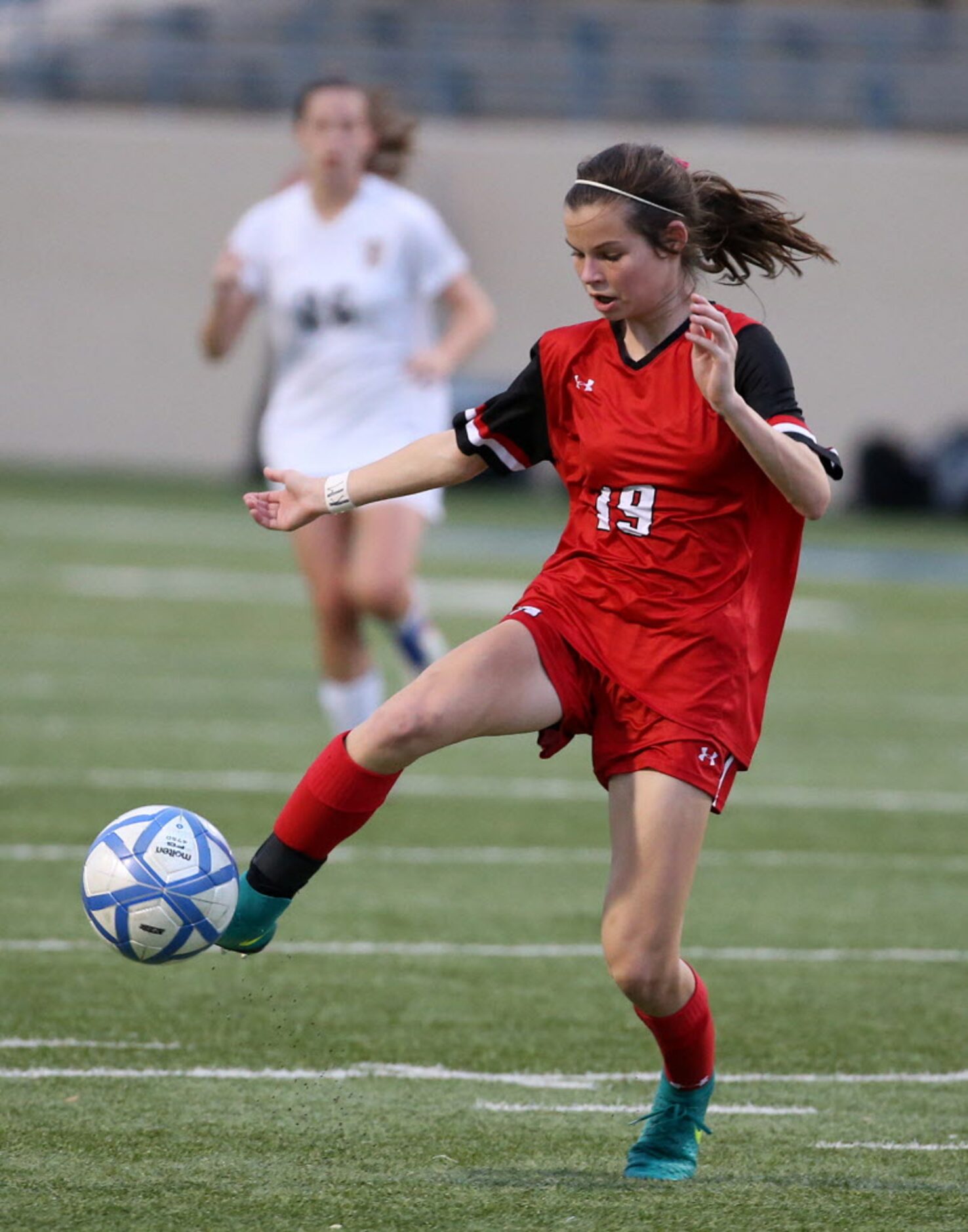 Ursuline Academys Katie Gay (19) takes the ball upfield against St. Agnes Academys in the...