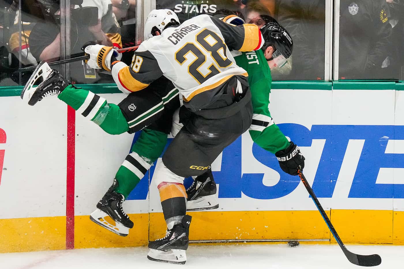 Dallas Stars defenseman Nils Lundkvist (5) is checked by Vegas Golden Knights left wing...