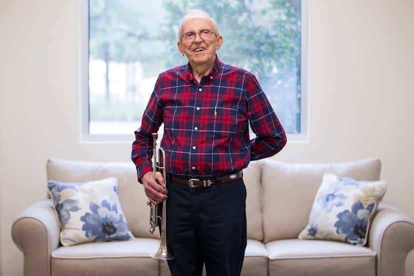 John Gould, 94, holds his trumpet while posing for a portrait in a common area of The...