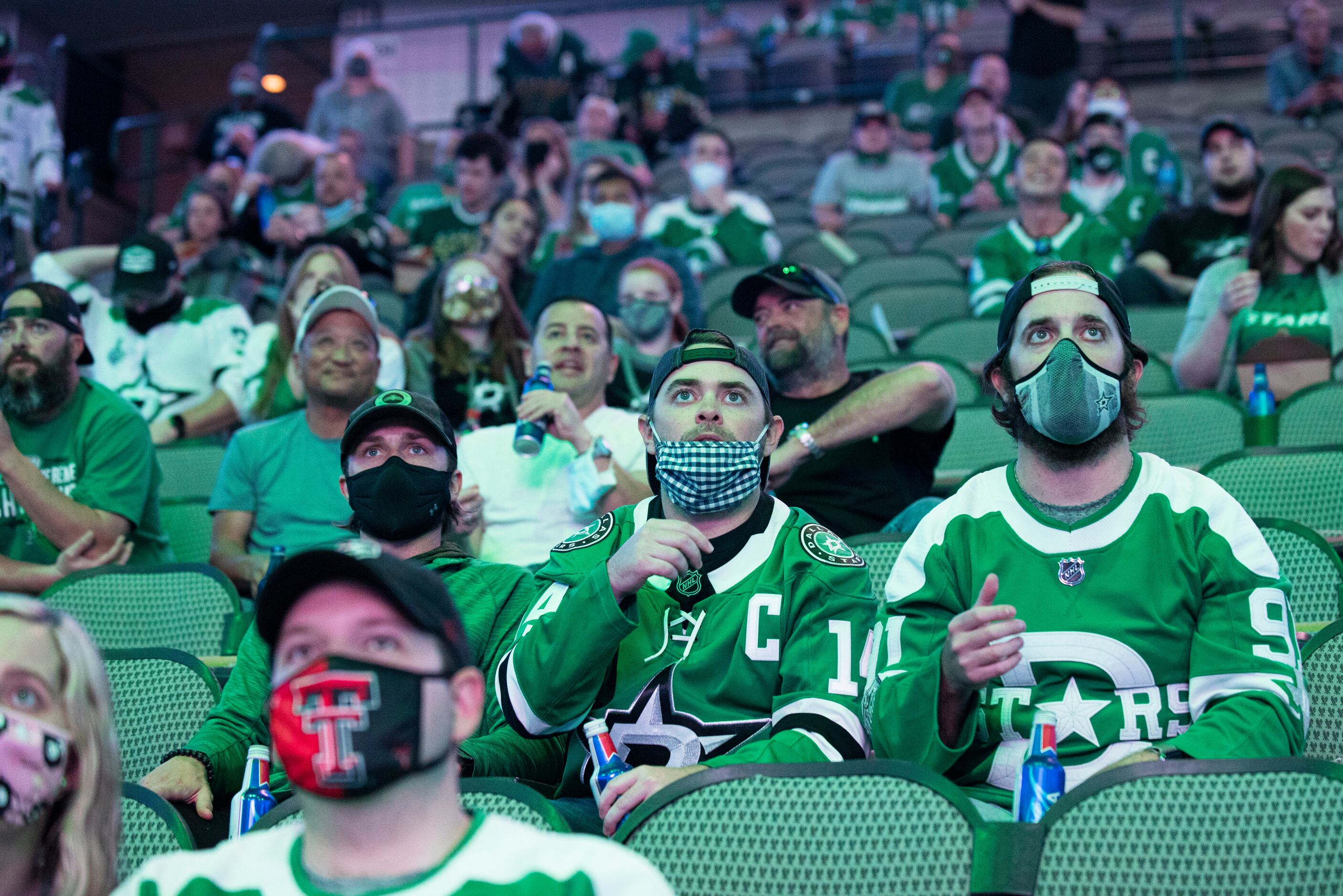 Hockey fans look at game play between the Dallas Stars and the Tampa Bay Lightning during a...